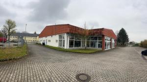 a building with a red roof on a street at Ferienwohnung Hainspitz Longstay in Hainspitz