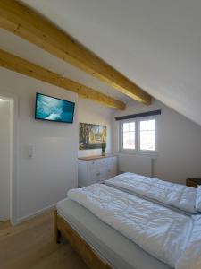 a bedroom with a large bed in a attic at Ferienhaus Das Petermännchen in Fehmarn