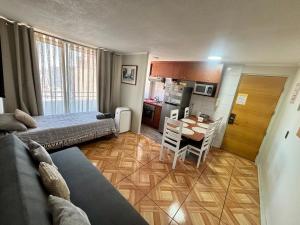 a room with two beds and a table and a kitchen at Inversiones Inmobiliarias AYD in Santiago
