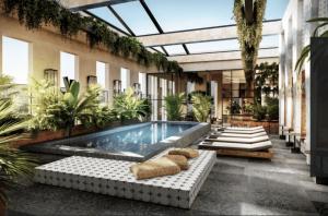 a pool in the middle of a building with plants at FAIRMONT NEW ORLEANS in New Orleans