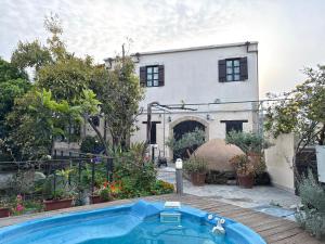 a swimming pool in front of a house at Vasilion Agrotourism in Polis Chrysochous