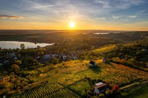 an aerial view of a small village on a hill with a sunset at Ferienwohnung Seese Wansleben am See in Wansleben