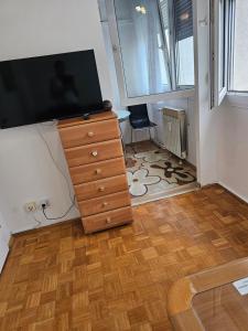 a living room with a dresser with a television on it at Apartman u Velikoj Gorici Željko in Velika Gorica