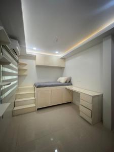 a room with a bench with a bed in it at Casa G in Bacong