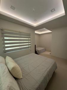 a bedroom with a large bed and a window at Casa G in Bacong +22 photos