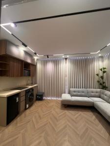 a living room with a couch and a kitchen at luxury rooftop apartment in Jeddah