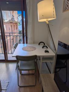 a desk with a lamp and a table with a chair at IM80 in Montroig