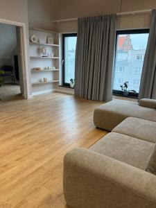 a living room with a couch and a large window at Apartamenty K17 Stare Miasto in Malbork