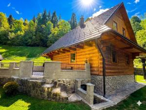 a log cabin with the sun in the background at Chata Sipkova II in Terchová