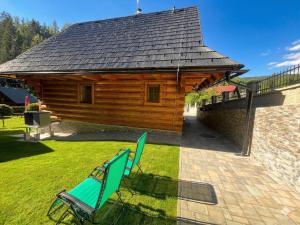 a pair of chairs in front of a cabin at Chata Sipkova II in Terchová