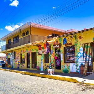 a yellow building with graffiti on the side of it at Hostal Inmaculada in Concepción de Ataco