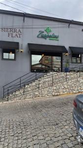 a building with windows and a stone wall at Flat 205 Zuppolini in Bananeiras