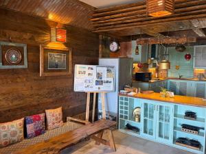 a kitchen with a counter and a bench in a room at MeenaBagh Villa Rooms & Cafe in Shimla +51 photos