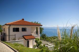 a house on a hill with a view of the ocean at Villa Alba Moscenicka Draga in Mošćenice