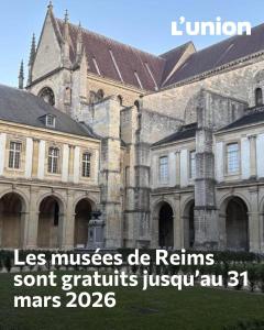 a large building with a sign in front of it at LEtape Prestige Hyper-Centre Calme in Reims