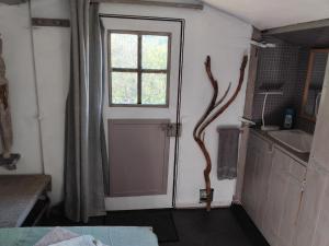 a door in a room with a window at Cabane sous les oliviers in Saint-Ambroix +25 photos