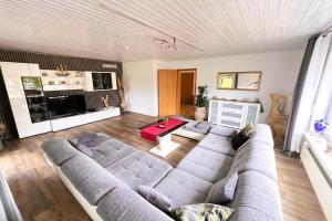 a living room with a couch and a table at Die Panorama-Wohnung-im-Grünem in Allensbach