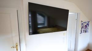 a flat screen tv on top of a door at Vienna Woods Residence in Gaaden