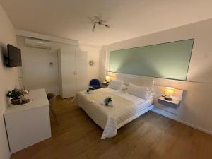 a bedroom with a large bed with two tables and two lamps at Corte Al Lago in Moniga