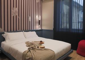 a bedroom with a bed with a tray of food on it at Lanza Luxury Home in Verona