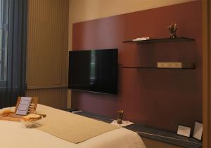 a hotel room with a bed and a flat screen tv at Lanza Luxury Home in Verona