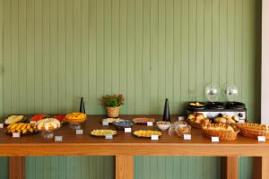 a table topped with lots of different types of food at Solar Flat Hotel in Juiz de Fora +25 photos