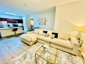 a living room with a white couch and a table at Cozy & Chic Frisco Scape in Frisco
