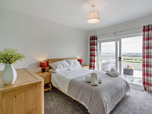 a bedroom with a bed and a large window at 3 Bed in Dumfries oc-96066 in Dumfries