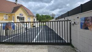 a black fence in front of a house at MADAME in Clérey