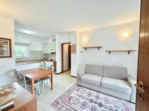 a living room with a couch and a table at Residence La Brughiera Malpensa in Lonate Pozzolo
