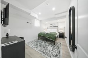 a white bedroom with a bed and a rug at Caledon Quiet Luxury Escape 3BR Suite in Brampton