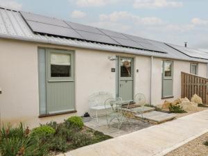 a house with solar panels on the roof at The Little Loft in Burford
