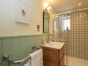 a bathroom with a sink and a shower at The Little Loft in Burford +19 photos