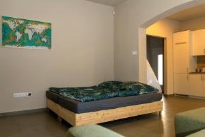 a bed in a room with a couch and a painting at Emma Casa Apartmant FREE Private Parking with EV supply availability in Budapest
