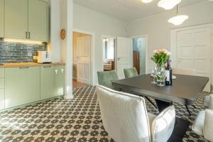 a kitchen and dining room with a table and chairs at Ágnes Villa Balatonföldvár in Balatonföldvár