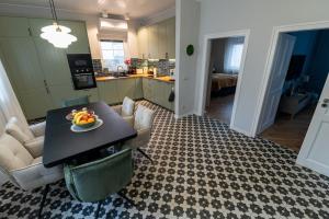 a living room with a table with a bowl of fruit on it at Ágnes Villa Balatonföldvár in Balatonföldvár