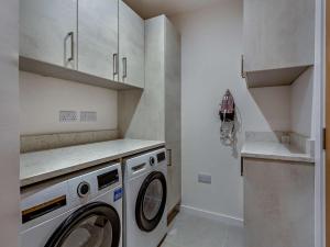 a laundry room with a washer and dryer at 1 Bed in Isle Of Skye oc-96201 in Glendale