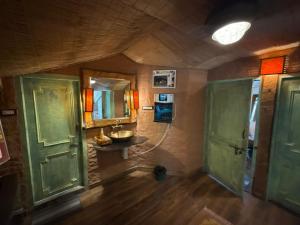 a room with a bathroom with a sink and a mirror at MeenaBagh Villa Rooms & Cafe in Shimla