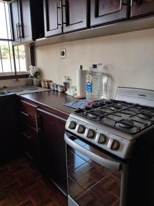 a kitchen with a stove and a counter top at Sucursal del Cielo in Concepción de Ataco