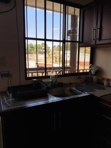 a kitchen counter with a sink and a window at Sucursal del Cielo in Concepción de Ataco +24 photos