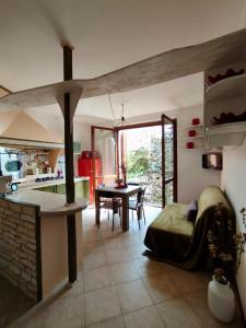 a kitchen and living room with a bed and a table at Elegant Penthouse LA BALCONATA - Wellness Retreat & Castle View in Tabiano