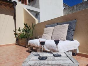 two glasses of wine on a table on a patio at Casa Alacantí in Pollença