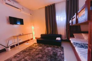 a room with a bed and a desk with a television at Stop-N-Stay Inn in Valencia
