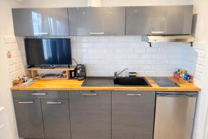 a kitchen with a sink and a counter top at Studette au centre des marina- smart in Villeneuve-Loubet