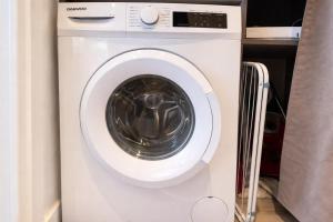 a white washing machine sitting in a room at Studette au centre des marina- smart in Villeneuve-Loubet