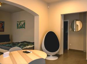 a living room with a table and a mirror at Emma Casa Apartmant FREE Private Parking with EV supply availability in Budapest