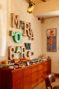 a restaurant with a sign that reads mainoza cafe at Lisboa Carmo Hotel in Lisbon