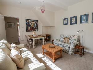 a living room with a couch and a table at Riverside Cottage in Llandrindod Wells