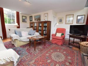 a living room with a couch and two chairs and a television at 2 Bed in Biggar oc-ca366 in Biggar