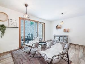a living room with two chairs and a couch at Apartment Lotus in Ovronnaz
